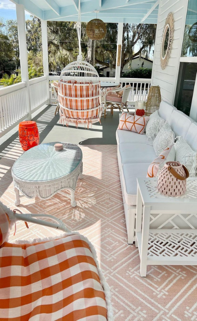 image of porch with white furniture and orange accents
